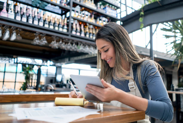 istock Female manager doing the books at a restaurant 828241386