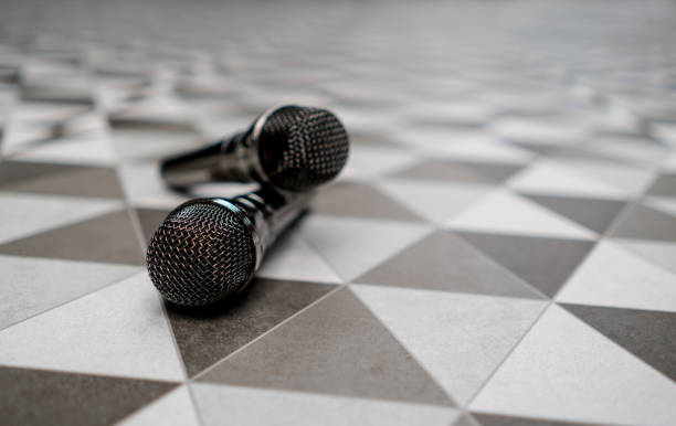 Close-up of a couple of microphones lying on the floor at a karaoke bar