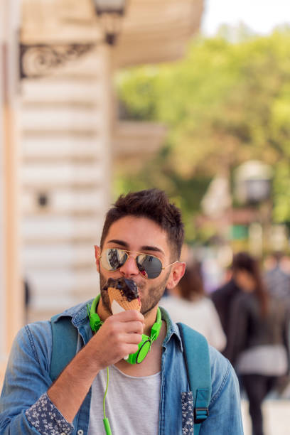 istock Young Adult Man Eating Ice-Cream 828245362