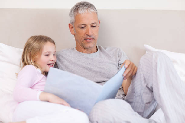 istock Father reading a story to his daughter 828246044