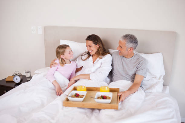 istock Girl having breakfast with her parents 828249026