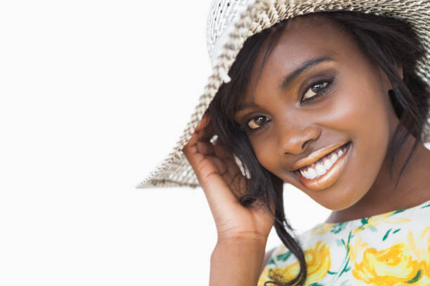 istock Woman smiling while wearing a summer hat 828283602