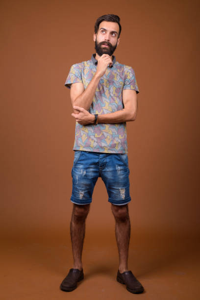 istock Studio shot of young handsome bearded Persian man against colored background 828287686