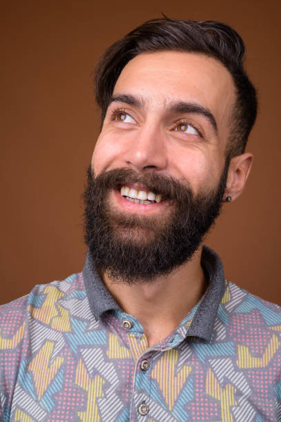 istock Studio shot of young handsome bearded Persian man against colored background 828290258