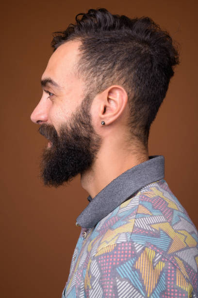 istock Studio shot of young handsome bearded Persian man against colored background 828290454