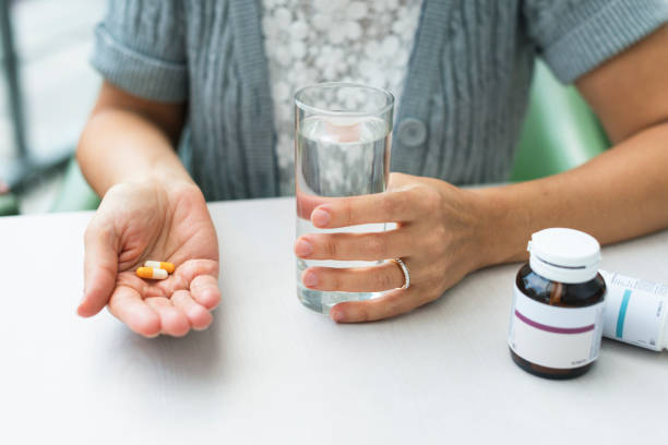 istock Hand holding a medicine and water ready to have it 828291224