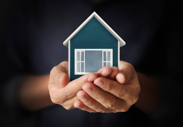 istock Mortgage concept by house from  hand 828298980