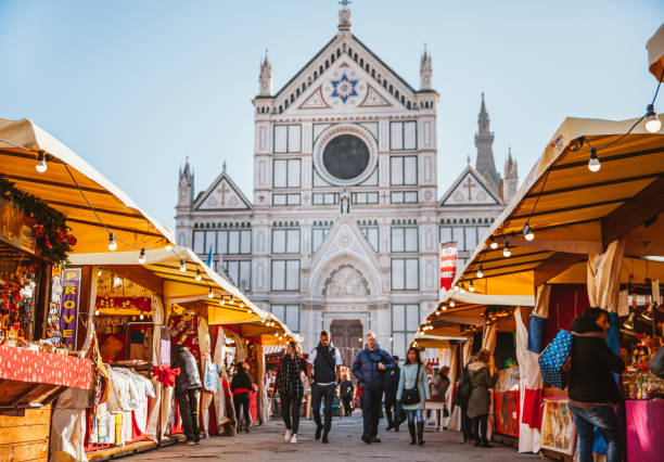 Christmas market in florence at Piazza Santa Croce Florence, Italy - December 11, 2015: View of Christmas market at the Piazza Santa Croce in Florence during the christian period with the christiam market. The place is full of people doing shopping on the city. piazza di santa croce stock pictures, royalty-free photos & images