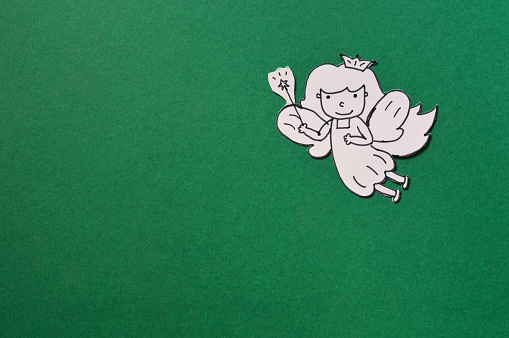 dental paper cut, cute tooth fairy isolated on green background