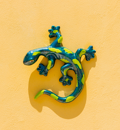 Ceramic Gecko wall decoration on yellow background