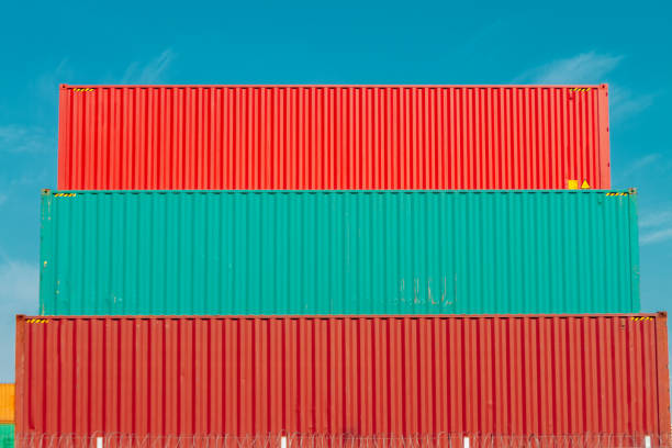 istock Three colored containers stacked in a port seen from side 828326544