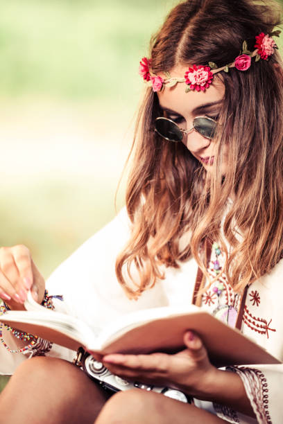 istock Hippie woman reading book 828328208