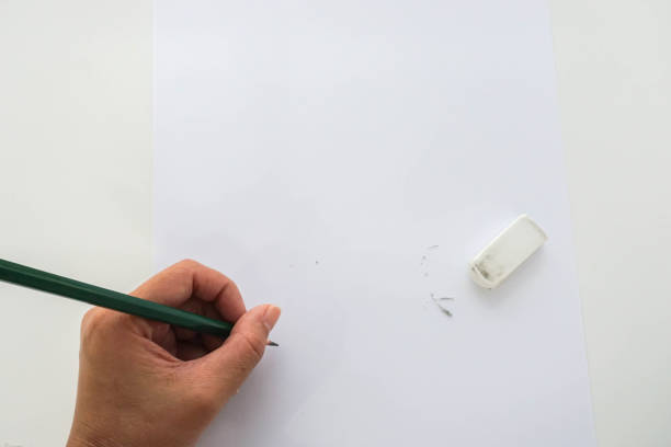 istock isolated close up people re-write on mock up paper after use rubber 828334028