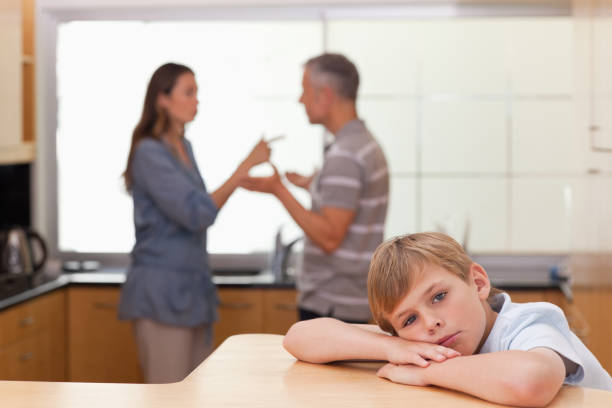 istock Sad little boy hearing his parents arguing 828337860