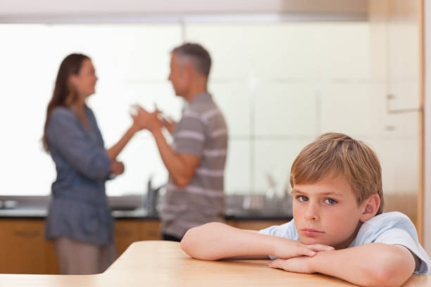 istock Sad boy hearing his parents having am argument 828337918