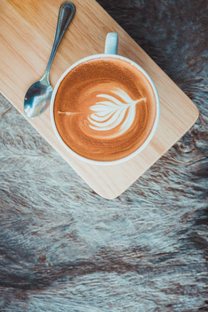 istock latte art coffee or cappuccino on wooden table background 828344946