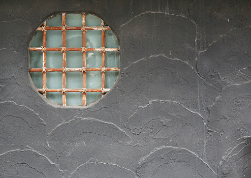 The beauty of Japanese decorative design window on the abstract gray cement wall.