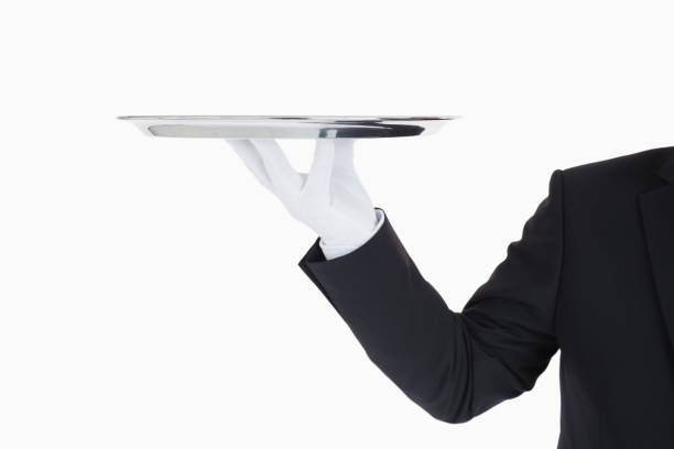 istock Hand with gloves holding a silver tray 828352532
