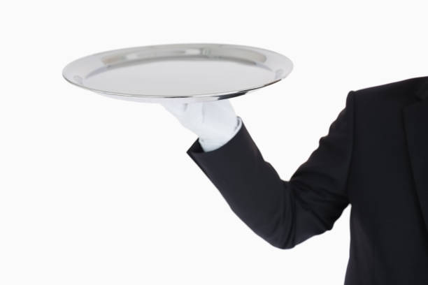 istock Hand with white gloves holding a silver tray 828352566