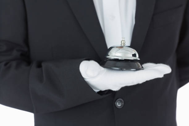 istock Man holding a hotel bell 828352756