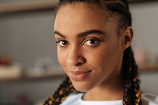 Close up photo of international girl that looking forward Kindness. Confident female person turning her head aside while posing on camera and keeping smile on face kindness mask stock pictures, royalty-free photos & images