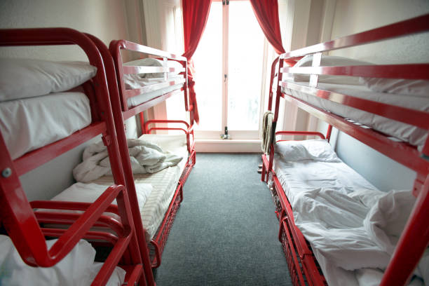 Beds in hostel room View of red stacking beds in light room of Bed Breakfast hotel. hostel photos stock pictures, royalty-free photos & images