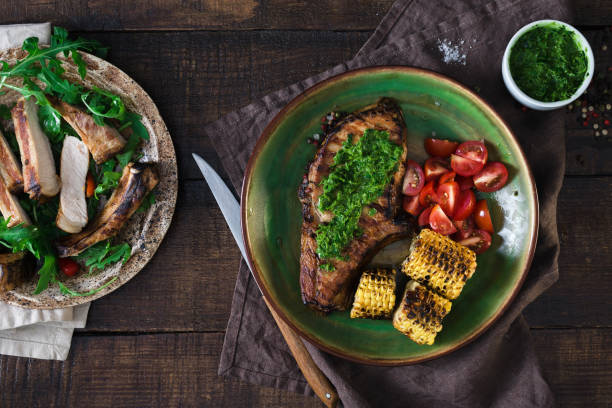 istock Steak on bone grill and salad in plate on wooden table 828368492
