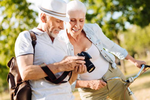 istock Positive delighted couple choosing best photos 828368918