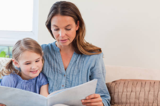 istock Mother reading a book to her daughter 828369254