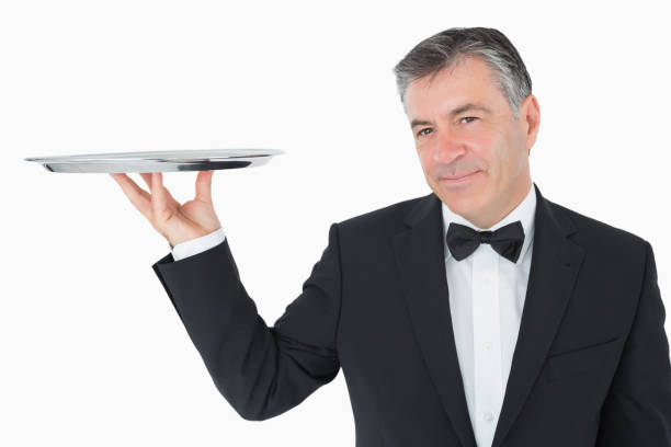 istock Welldressed waiter holding a silver tray 828369560