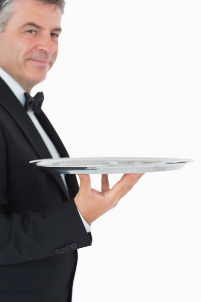 istock Waiter holding a silver tray with his hand 828369790