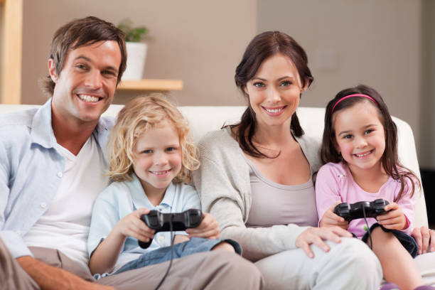 istock Smiling family playing video games together 828372154