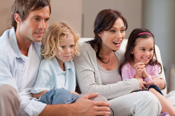 istock Cheerful family watching television together 828372186