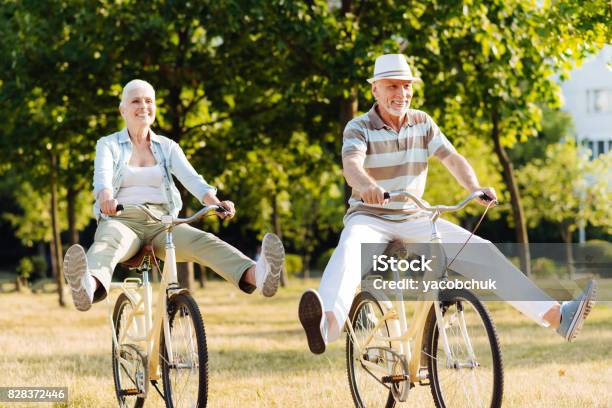Joyful Woman Feeling Happiness While Cycling Stock Photo - Download Image Now - Aging Process, Senior Adult, Cycling