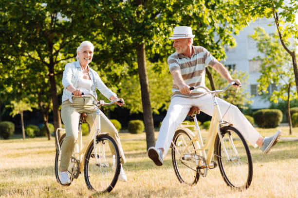istock Positive delighted couple while cycling in park 828372614