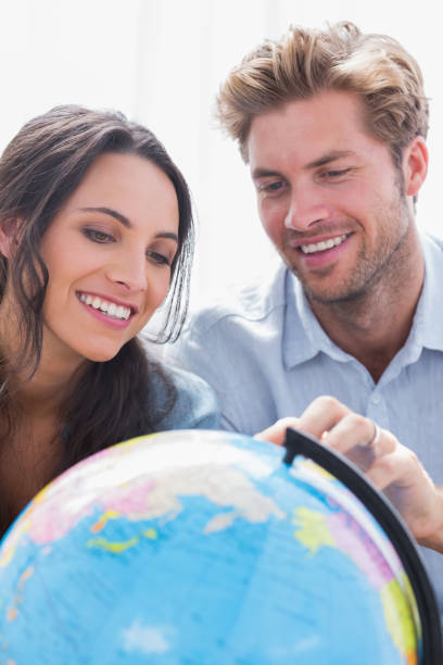 istock Happy couple looking at a globe 828377162