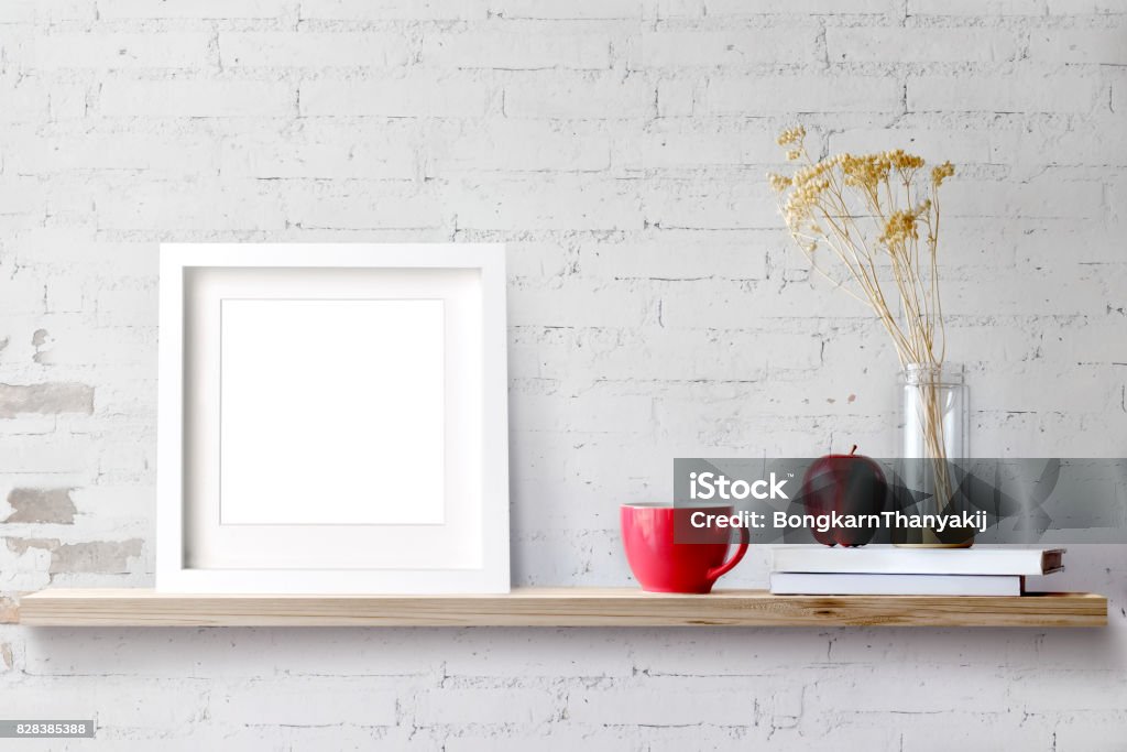 Wood shelf with blank white frame and coffee. Wood shelf with blank white frame and coffee. Blank screen for products or graphic montage. Picture Frame Stock Photo