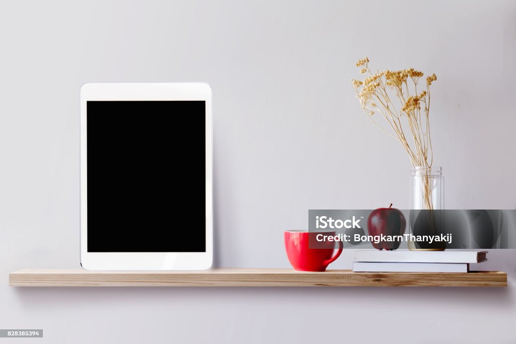 Wood shelf with tablet and coffee. Wood shelf with tablet and coffee. Blank screen for products or graphic montage. Digital Tablet Stock Photo