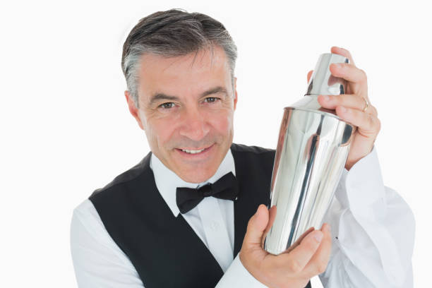 istock Smiling waiter shaking drink in cocktail shaker 828393274