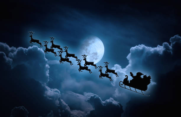 istock Silhouette of Santa Claus flying on sleigh pulled by reindeer. 828399744