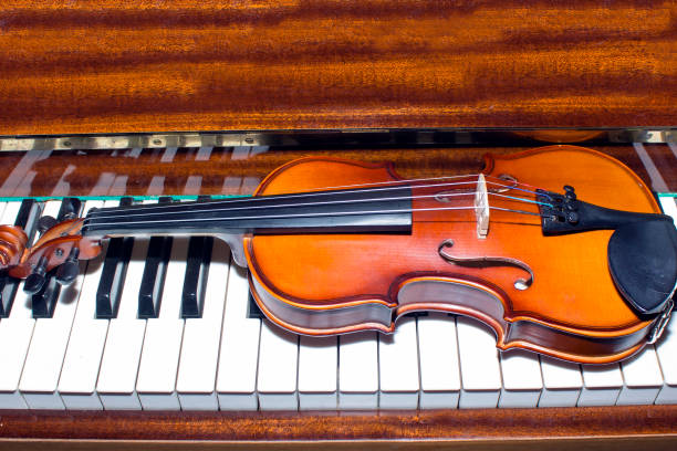 istock Very old violin lying on the piano 828399978