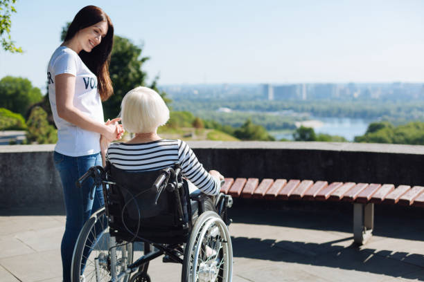 istock Devoted bright girl holding elderly lady by the hand 828400998
