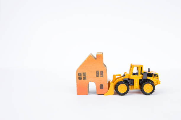 istock Front loader truck moving wooden miniature house isolate on white background 828403804