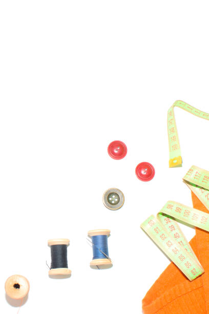 istock Coil with thread, scissors and ruler on a piece with a bright cloth, on a white background 828404224