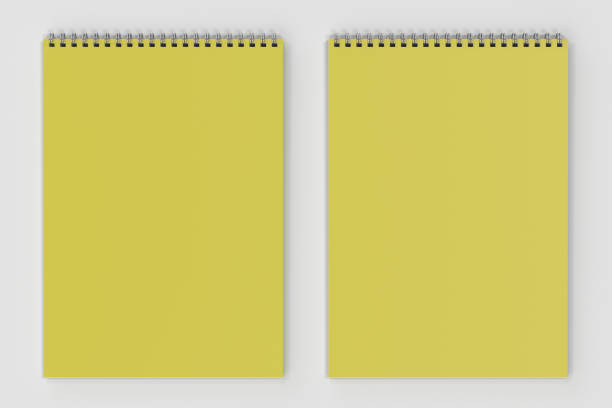 istock Blank yellow notebook with metal spiral bound on white background 828405178
