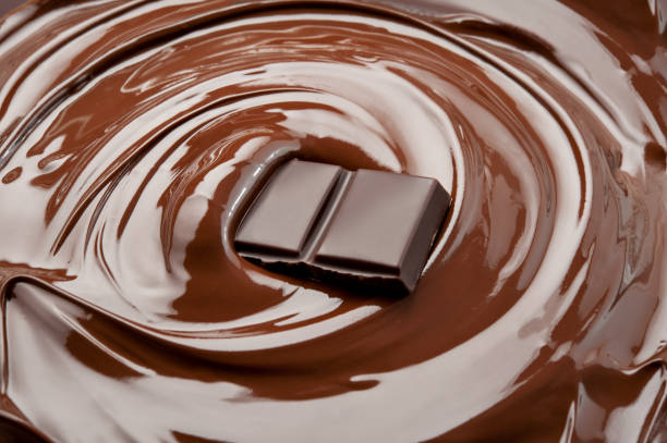 istock Melted piece of chocolate in chocolate swirl. 828405266