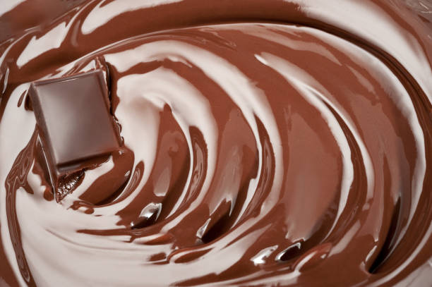 istock Melted piece of chocolate in chocolate swirl 828405328