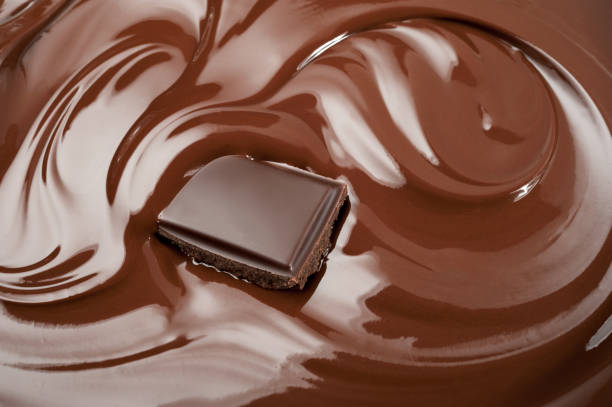 istock Melted piece of chocolate in chocolate swirl 828405378