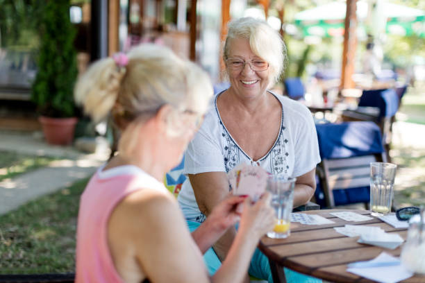 istock Senior friends playing cards 828408562