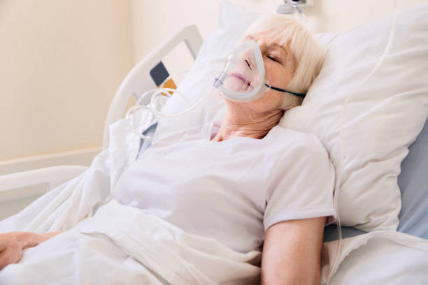 istock Unconscious elderly woman wearing an oxygen mask 828408806